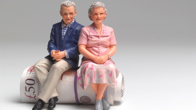 Article thumbnail: Retired couple sitting on roll of UK pounds