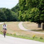 Article thumbnail: A cyclist travels through Richmond Park as the Government launches a strategy to get more people cycling. Thousands of miles of new protected bike lanes, cycle training for everyone and bikes available on prescription will be rolled out under new plans to overhaul cycling and walking in England. PA Photo. Picture date: Tuesday July 28, 2020. See PA story TRANSPORT Cycling. Photo credit should read: Jonathan Brady/PA Wire