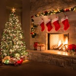 Article thumbnail: Glowing Christmas fireplace and living room, with tree, and stockings hanging from mantel by fireplace.Waiting for Santa.