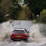Article thumbnail: A car drives along a flooded road in Romsey, southern England, on November 2, 2023 as strong winds and heavy rain from Storm Ciaran hits Britain. High winds and heavy rain brought by storm Ciaran caused major disruption in southern England on November 2, 2023, with shipping from the port of Dover suspended for several hours and hundreds of schools closed. Winds of up to 100/110 km/h were expected in the morning, and up to 100 km/h in the afternoon, according to the weather forecast on the British government website. (Photo by Adrian DENNIS / AFP) (Photo by ADRIAN DENNIS/AFP via Getty Images)
