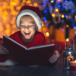 Article thumbnail: Surprised child opening magic Christmas book. Xmas holiday concept