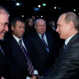 Article thumbnail: FILE - Then-Russian Prime Minister Vladimir Putin, right, congratulates members of the Russian delegation, from left: conductor Valery Gergiyev, businessman Roman Abramovich and Nizhny Novgorod Gov. Valery Shantsev; after it was announced that Russia would host the 2018 soccer World Cup in Zurich, Switzerland, Dec. 2, 2010. When Putin came to power in 2000, the outside world viewed Russia's "oligarchs" as men who whose vast wealth made them almost shadow rulers. Putin was reported to have told about two dozen of the men regarded as the top oligarchs in a meeting later in 2000 that if they stayed out of politics, their wealth wouldn't be touched. (AP Photo/Alexei Nikolsky, Pool, File)