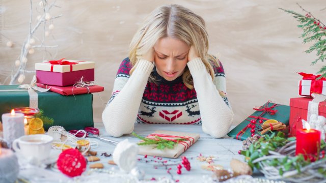 Article thumbnail: Exhausted and overwhelmed woman packing Christmas gifts