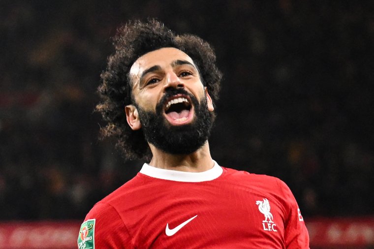 Liverpool's Egyptian striker #11 Mohamed Salah celebrates after scoring his team fourth goal during the English League Cup quarter-final football match between Liverpool and West Ham United at Anfield in Liverpool, north west England on December 20, 2023. (Photo by Oli SCARFF / AFP) / RESTRICTED TO EDITORIAL USE. No use with unauthorized audio, video, data, fixture lists, club/league logos or 'live' services. Online in-match use limited to 120 images. An additional 40 images may be used in extra time. No video emulation. Social media in-match use limited to 120 images. An additional 40 images may be used in extra time. No use in betting publications, games or single club/league/player publications. / (Photo by OLI SCARFF/AFP via Getty Images)