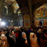 Article thumbnail: Believers pray during a Christmas Eve service at the St. Michael's Golden-Domed Cathedral (Mykhailivskyi Zolotoverkhyi) as Ukrainians celebrate their first Christmas according to a Western calendar, amid Russia's attack on Ukraine, in Kyiv, Ukraine December 24, 2023. REUTERS/Valentyn Ogirenko